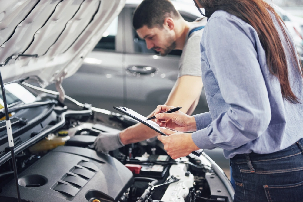 a-man-mechanic-and-woman-customer-look-at-the-car-hood-and-discuss-repairs 1.jpg